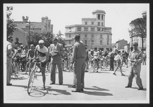 I corridori in piazza della Vittoria a Forlì insieme ad altre persone, probabilmente organizzatori della corsa, membri della giuria e tecnici