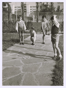 Bambini che giocano alle piastre in un parco giochi, probabilmente quello del Villaggio Pirelli di Cinisello Balsamo