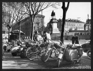 Scooters Lambretta e Vespa a Milano, in piazza Diaz: sullo sfondo sono visibili il palazzo dell'Arengario e le guglie del Duomo