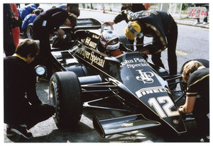 Il pilota Nigel Mansell su Lotus-Ford Cosworth n. 12 ai box, insieme a tecnici e meccanici
