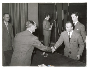 Luigi Rossari premia Giulio Paparelle ed Eraldo Colombo per l'hockey. La fotografia è pubblicata nell'articolo Festa dell'Atleta in Fatti e Notizie n. 2, 1955