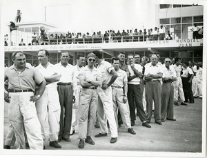 Corridori e meccanici aspettano il Presidente argentino Juan Domingo Perón alla corsa automobilistica di Buenos Aires del 1952. Da sinistra a destra si riconoscono José Froilán González e Juan Manuel Fangio.